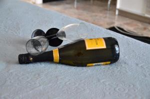 a bottle of wine with glasses on a table at Le Sculture B&B in Cosenza