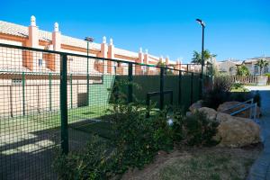 a fence in front of a building at Zahara Sol Villas y Apartamentos by QHotels in Zahara de los Atunes