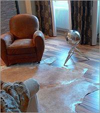 a room with a chair and a mirror on the floor at Elements Hotel in Regensburg