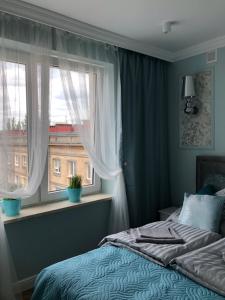 a bedroom with a bed and a window at Family & Business Sauna Apartments Paderewskiego Sienkiewicza No2 Centrum Downtown - 2 Bedroom with Private Sauna, Bath with Hydromassage, Parking in Kielce