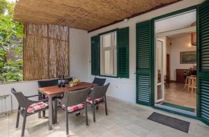 a patio with green shutters and a table and chairs at PLR-Royal luxury apartment in Split