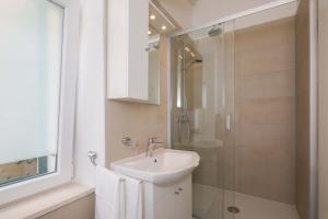 a bathroom with a sink and a glass shower at PLR-Royal luxury apartment in Split +58 photos