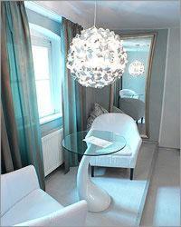 
a small room with a white table and a large mirror at Elements Hotel in Regensburg
