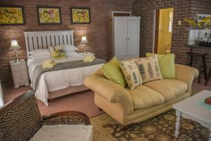 a bedroom with a bed and a couch at Clarens Retreat in Clarens