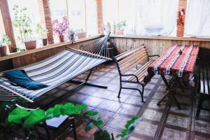 a hammock in a room with a table and a table and a tableablish at Mini-Hotel Şara Talyan and Tours in Yerevan