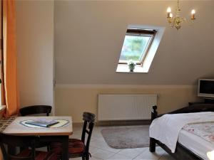 a bedroom with a table and a window at Spacious Apartment in Boltenhagen with Garden in Tarnewitz