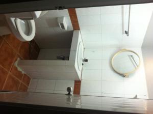 a bathroom with a mirror on the wall and a sink at White Orchid Inn I in Bangkok