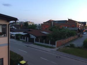 a view of a street with houses and a fence at Rooms & Apartments MURGLE Ljubljana in Ljubljana