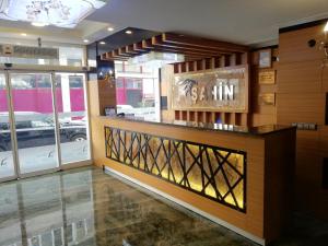 a restaurant with a counter in a room with windows at BURSA ŞAHiN HOTEL in Bursa