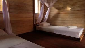 Ein Bett oder Betten in einem Zimmer der Unterkunft Beranda Ecolodge