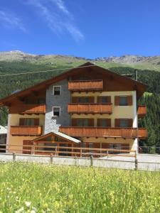 a building with balconies on the side of it at Casa Vacanze Michela in Santa Caterina Valfurva
