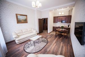 a living room with a couch and a table at ASAO-Apartments walking center zone in Lviv