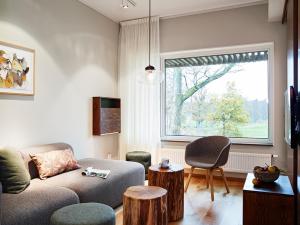 a living room with a couch and a window at Öijared Resort in Floda