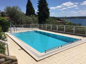 a large swimming pool next to a metal fence at Baki Portorose in Portorož