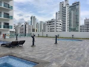 a courtyard with a pool in a city with tall buildings at Luxury Infinitum in Cartagena de Indias