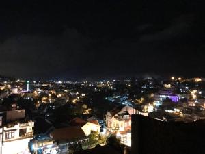 a view of a city at night with lights at Dalat Memory Inn in Da Lat