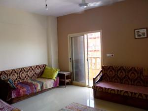 a living room with a couch and a sliding glass door at Three-Bedroom Chalet at Lotus Resort (Families Only) in El Alamein