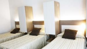 Postel nebo postele na pokoji v ubytování Hôtel La Source