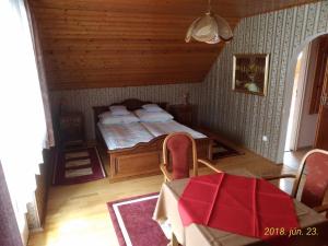 a bedroom with a bed and a table in a room at Jakab Ház in Hévíz