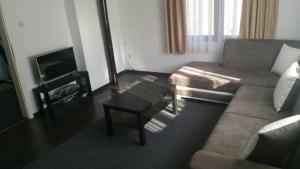 a living room with a couch and a coffee table at Smart and Cozy Nature House in Belogradchik