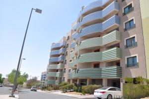 a large apartment building with a car parked in front at New Abha Resort in Abha