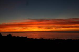a sunset over a body of water with the sky at Zahara Sol Villas y Apartamentos by QHotels in Zahara de los Atunes