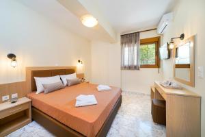 a bedroom with a large bed and a mirror at Villa Karydies in Limenas