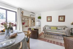 a living room with a table and a couch at Domaine Sesquier Mas d'exception Belle de Nuit in Mèze