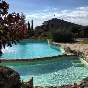 a swimming pool in the yard of a house at Residenza Cornino in Castellina in Chianti