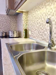 a stainless steel sink in a kitchen at Mersina Apartments in Keri