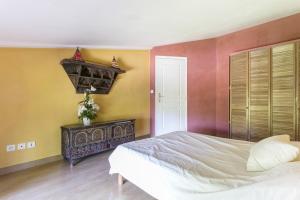 a bedroom with a white bed and yellow walls at Domaine Sesquier Mas d'exception Acacia in Mèze