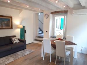 a living room with a couch and a table and chairs at Residenza Borgo Antico in Monte Isola