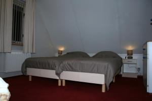 מיטה או מיטות בחדר ב-Vakantiepark de Bronzen Eik