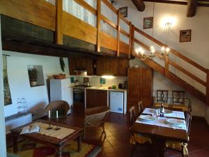 a kitchen and dining room with a table and chairs at Residenza Cornino in Castellina in Chianti