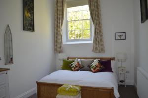 a bedroom with a bed and a window at The Old Chapel Boutique B&B in Towcester