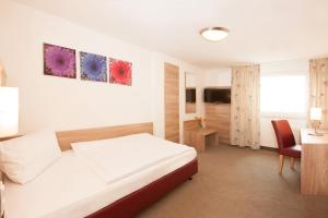 Säng eller sängar i ett rum på Hotel Schützenburg