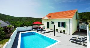 a villa with a swimming pool and a house at House Lucia in Brštanovo