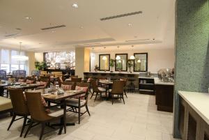 een restaurant met tafels en stoelen en een bar bij The Executive Hotel in Panama-Stad