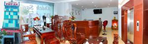 a living room filled with furniture and a piano at Khách sạn Phú An in Cà Mau