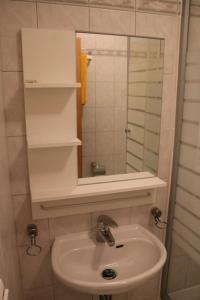 a bathroom with a sink and a mirror at Ferienappartement am See II im Biospharenreservat Schorfheide in Schorfheide