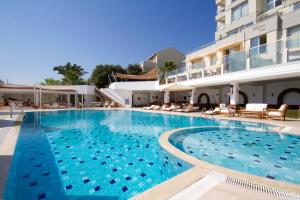 a large swimming pool in front of a building at Dalyan Residence & Suites in Cesme