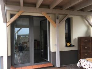 an extension to a house with a sliding glass door at Appartment Maggy in Bad Liebenwerda