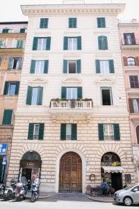 a large white building with a balcony on top of it at Nerva Accomodation Cavour in Rome