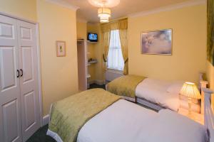 A bed or beds in a room at The Devonian 