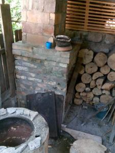 a brick oven with a pile of fire wood at Guest House Borjomi in Borjomi