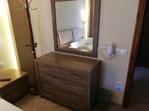 a bathroom with a dresser with a mirror on it at Giannis & Foteini in Afitos