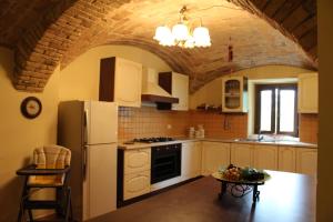 a kitchen with a white refrigerator and a table at Villa Sarno in Montesilvano