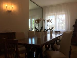 a dining room table with vases of flowers on it at Robin Rooms in Montegranaro