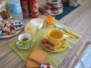 a table with two cups of coffee and a plate of food at B&B Piazza di L'Ara in Tempio Pausania