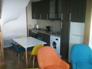 a kitchen with a white table and chairs and a sink at Casa D.Dinis in Vide